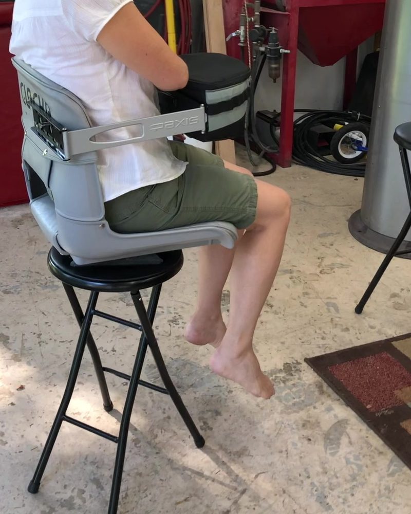The pack in front of the seated user, on the swing arm