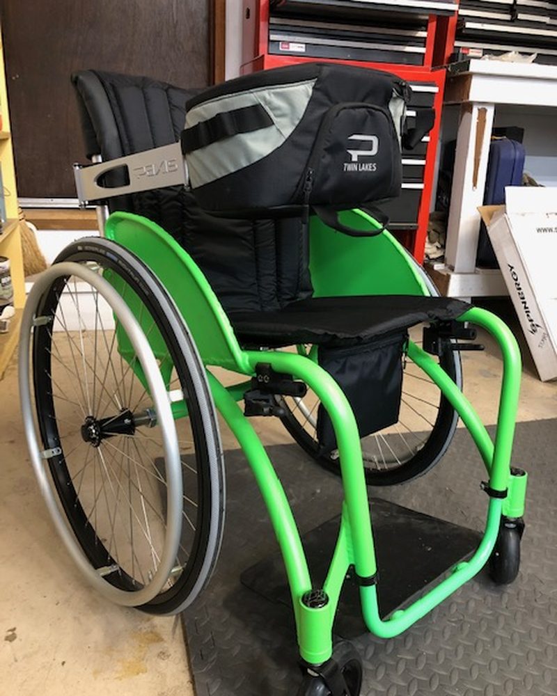 The swing arm carrying the pack around the side of the chair